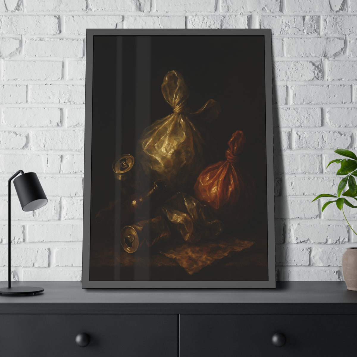 Two knotted plastic bags and crushed cans on a dark table. The Knotted Offering by Garabaggio, framed fine art print hanging in a room.
