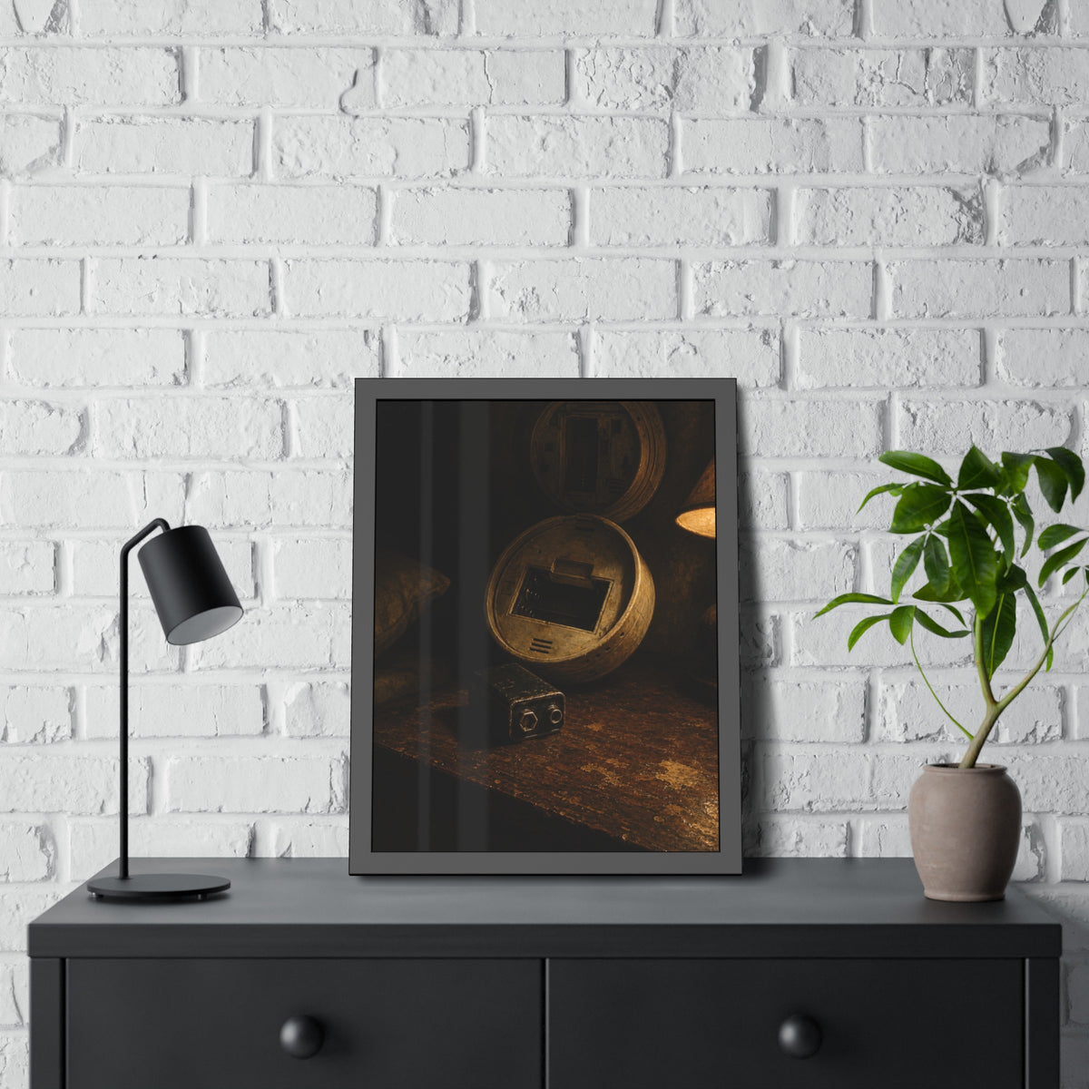 An open smoke detector on a wooden table beside a removed nine volt battery. The Silence After Removal by Garabaggio, framed fine art print hanging in a room.