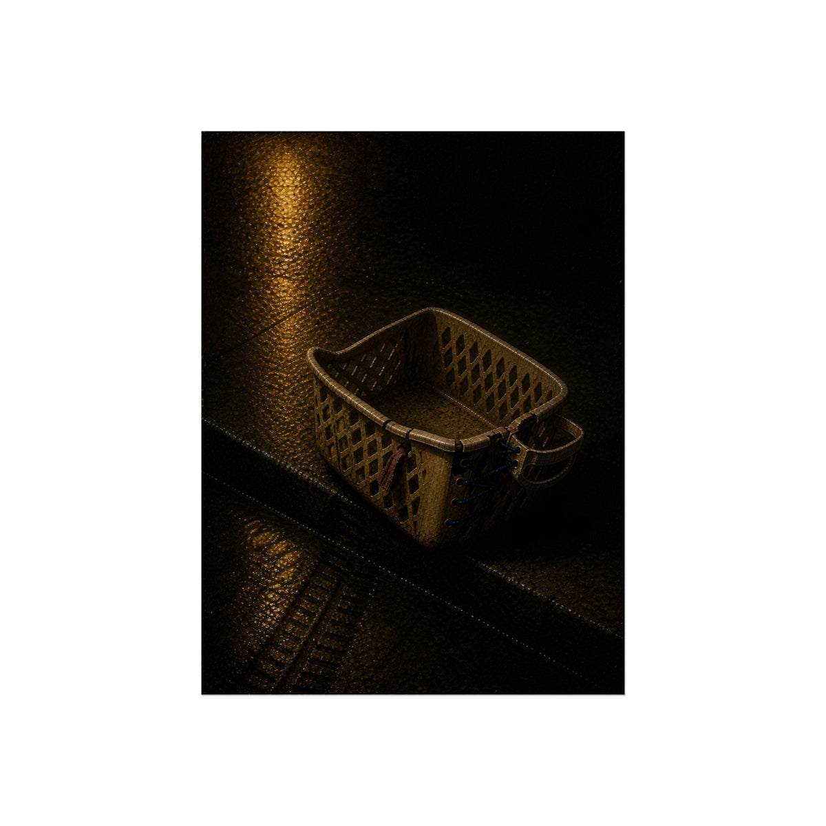 A cracked plastic laundry basket with a warped rim on wet asphalt. The Crushing of the Rim by Garabaggio, fine art print, 12″ x 16″.