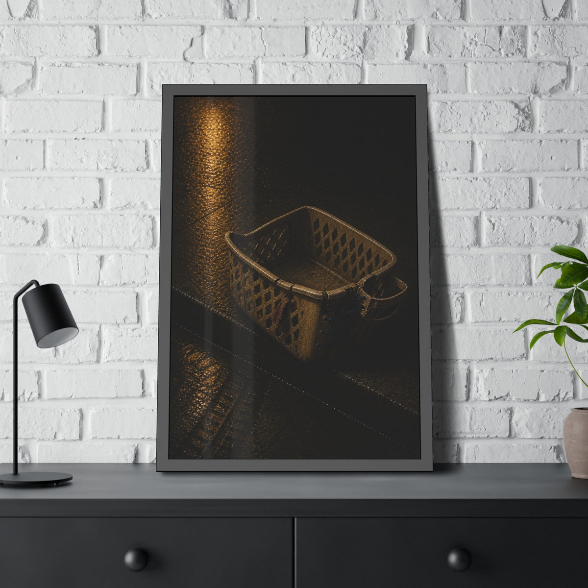 A cracked plastic laundry basket with a warped rim on wet asphalt. The Crushing of the Rim by Garabaggio, framed fine art print hanging in a room.