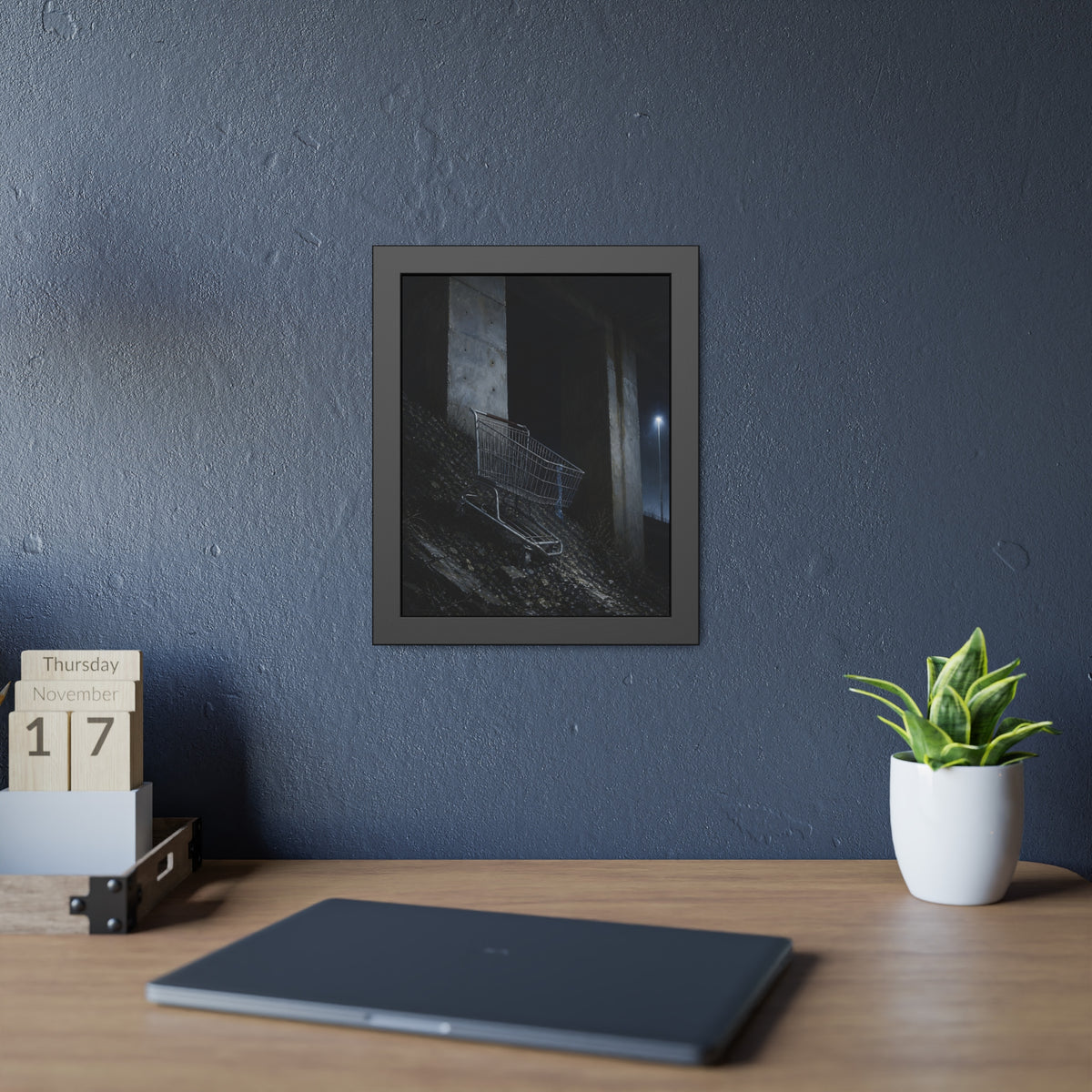 A shopping cart on a rocky slope under an overpass near a streetlamp. The Descent to the Underpass by Garabaggio, framed fine art print hanging in a room.