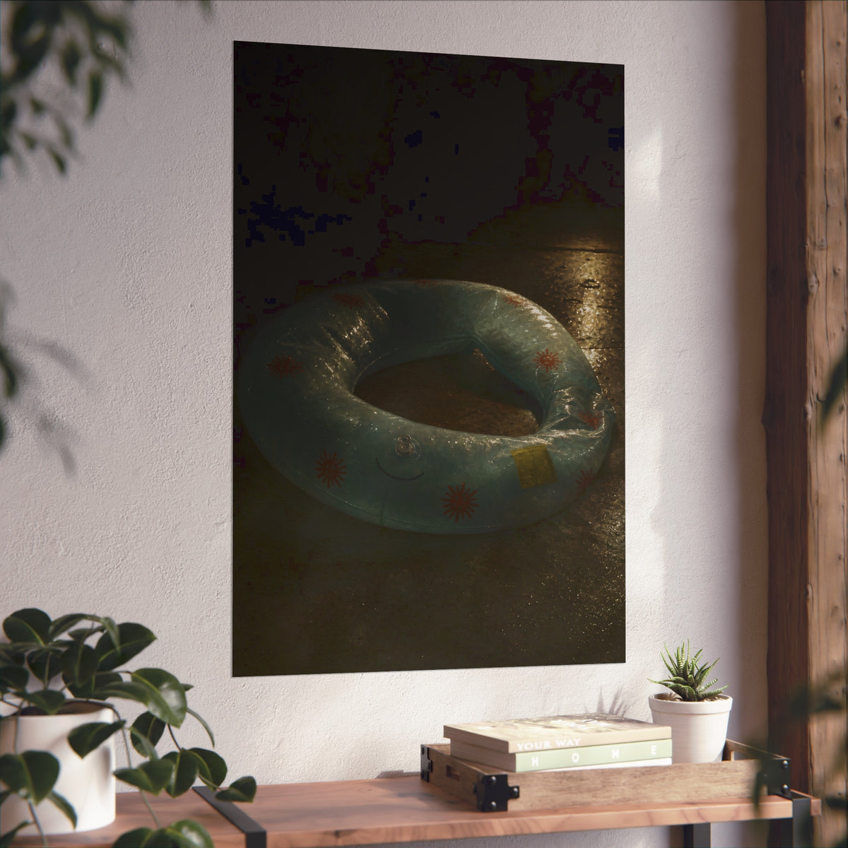Deflated pool float ring on wet ground, lit from one side in the dark. After the Last Swim by Garabaggio, fine art print hanging in a room.