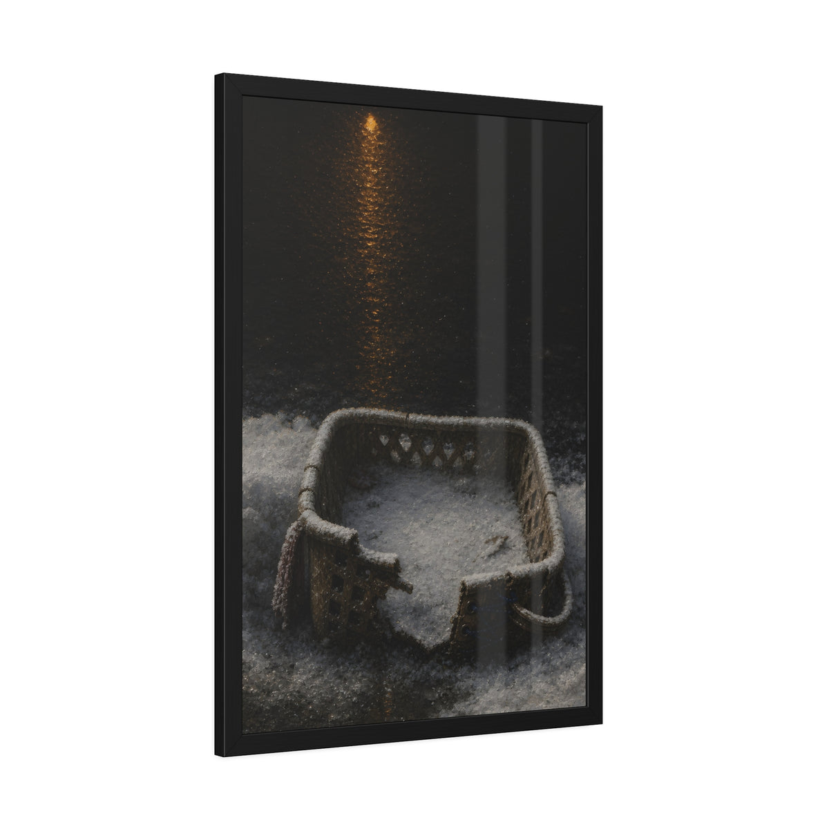 A cracked laundry basket half buried in snow under a distant lamp. The First Snow by Garabaggio, framed fine art print hanging in a room.
