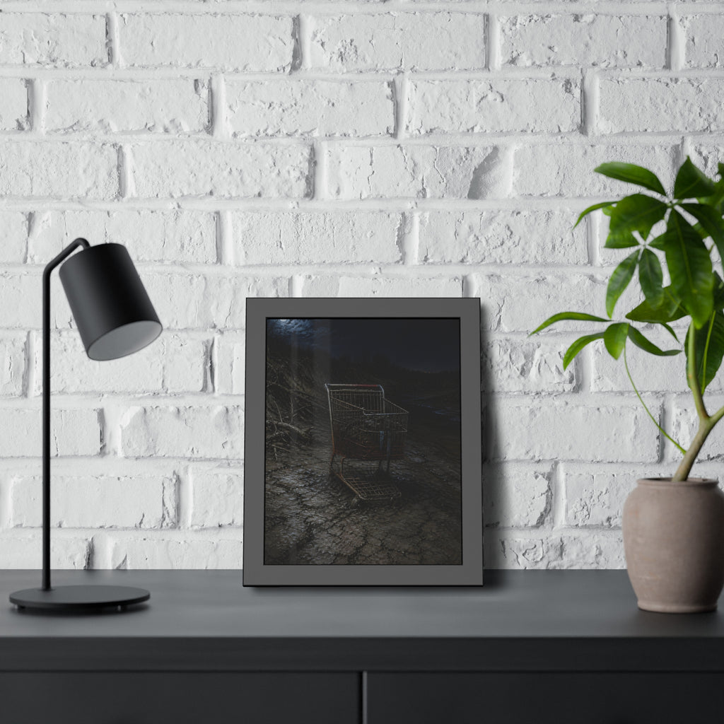 A rusted shopping cart sunk in cracked dried mud under a full moon. The Silting by Garabaggio, framed fine art print hanging in a room.