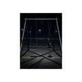 An empty swing set at night with one seat twisted up on its chains. The First Hour: The Twisted Seat by Garabaggio, fine art print, 12″ x 16″.