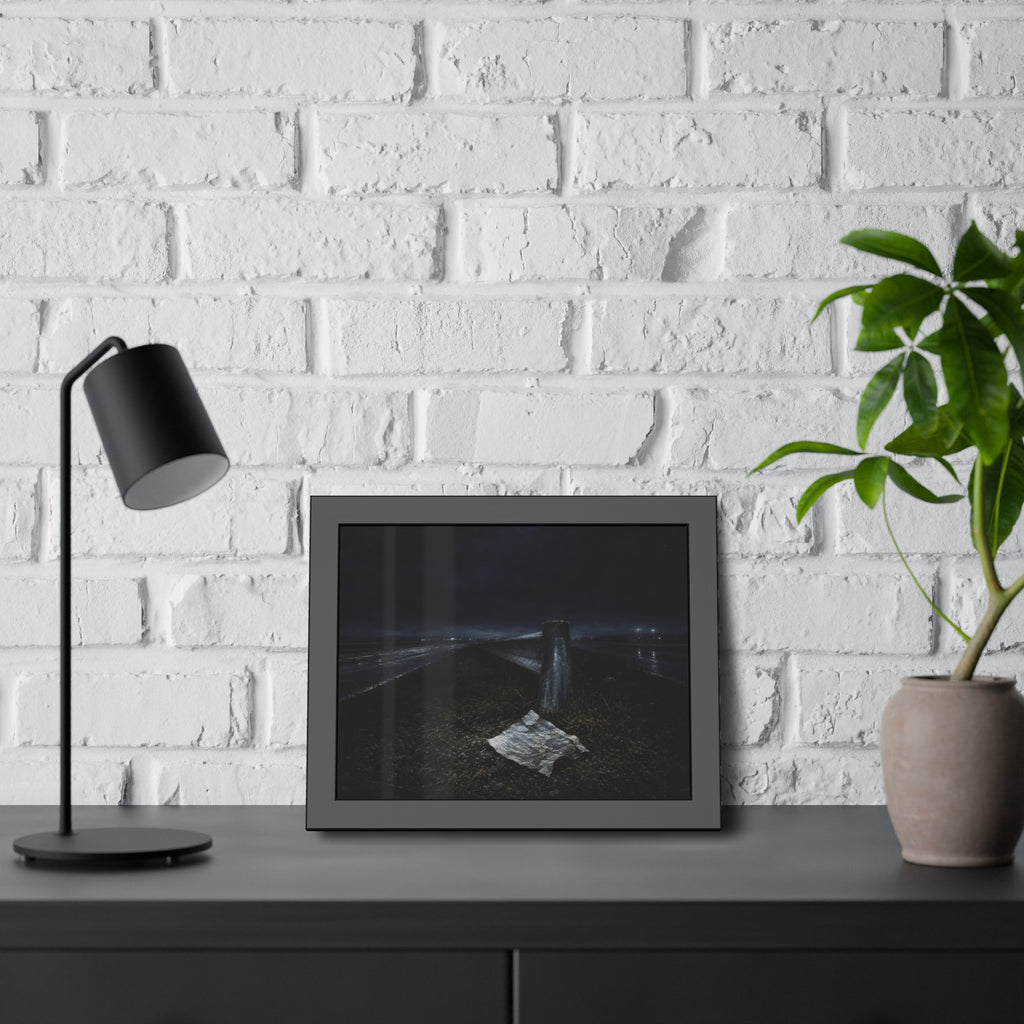 A sheet of paper on a grassy highway median beside a concrete post at night. The Resume on the Median by Garabaggio, framed fine art print hanging in a room.