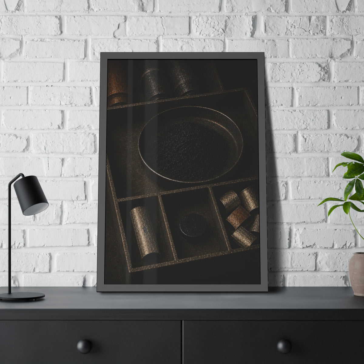 Battery casings and black powder sorted into the trays of a dim box. The Black Recovery by Garabaggio, framed fine art print hanging in a room.