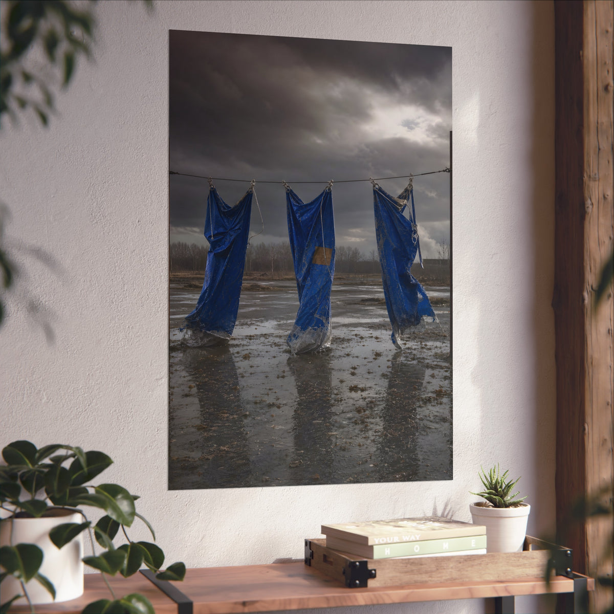 Three blue tarps hung from a wire over a wet lot under storm clouds. Banners After the Gale by Garabaggio, fine art print hanging in a room.