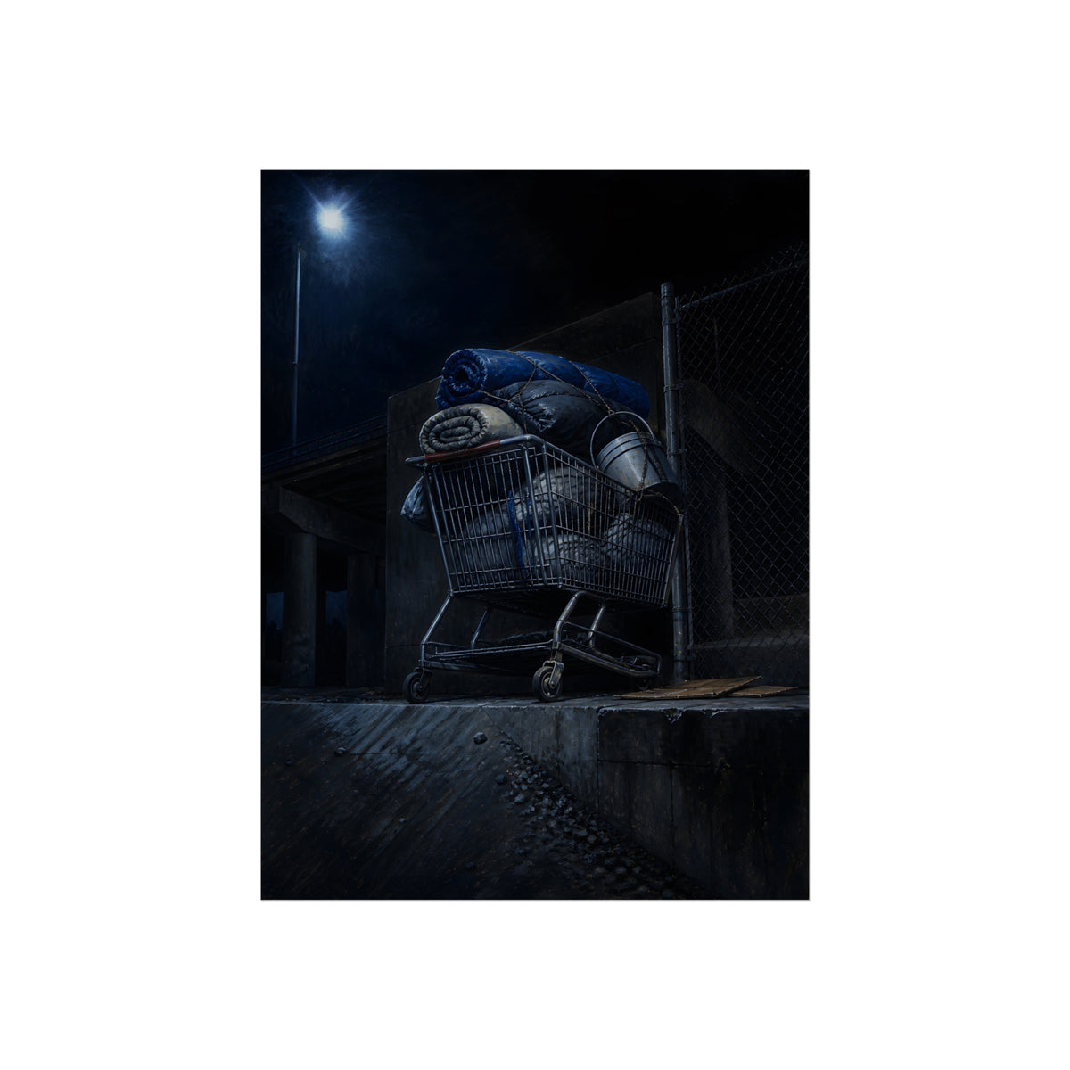 A shopping cart piled with bedding and buckets under a streetlamp. The Loading of Another Life by Garabaggio, fine art print, 12″ x 16″.