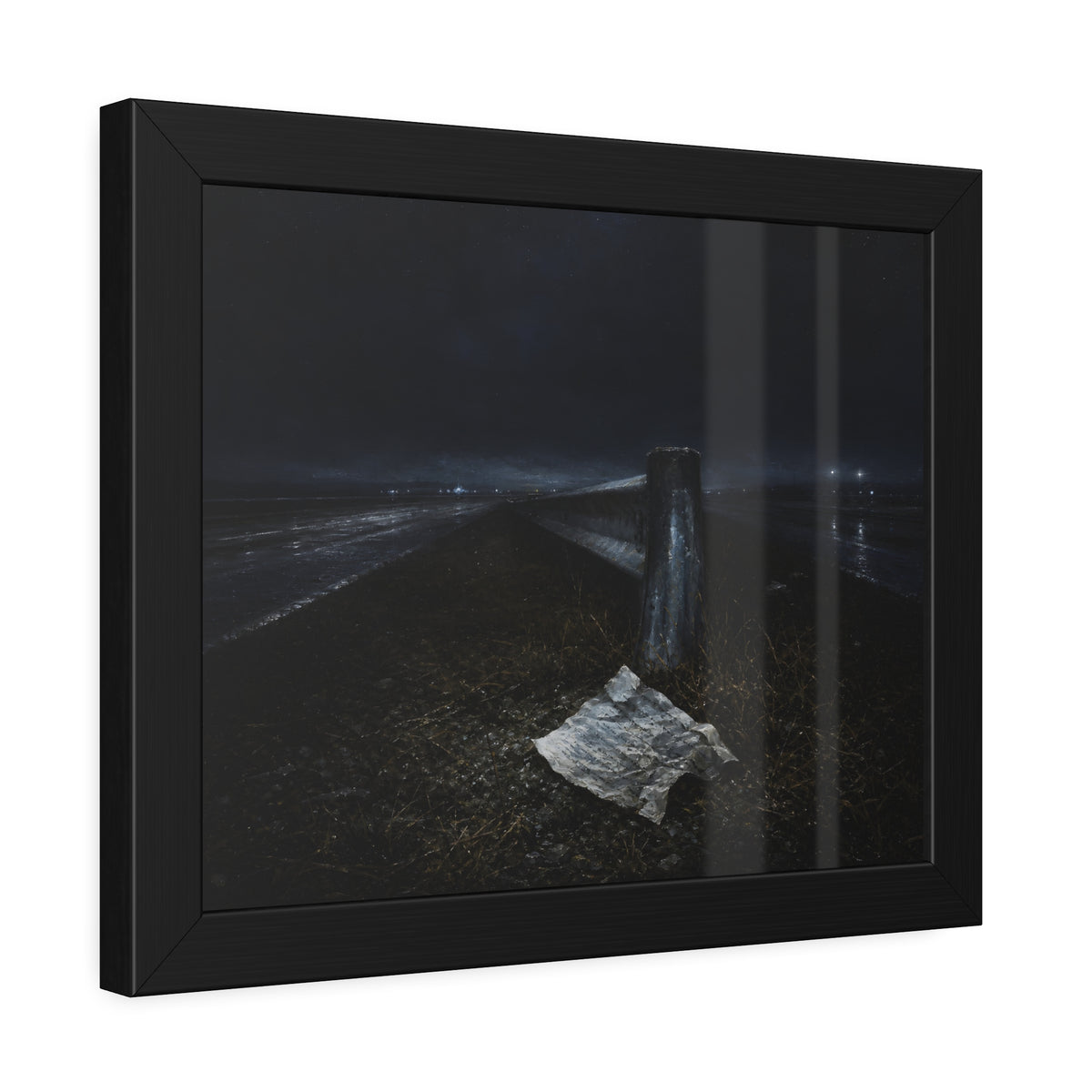 A sheet of paper on a grassy highway median beside a concrete post at night. The Resume on the Median by Garabaggio, framed fine art print hanging in a room.
