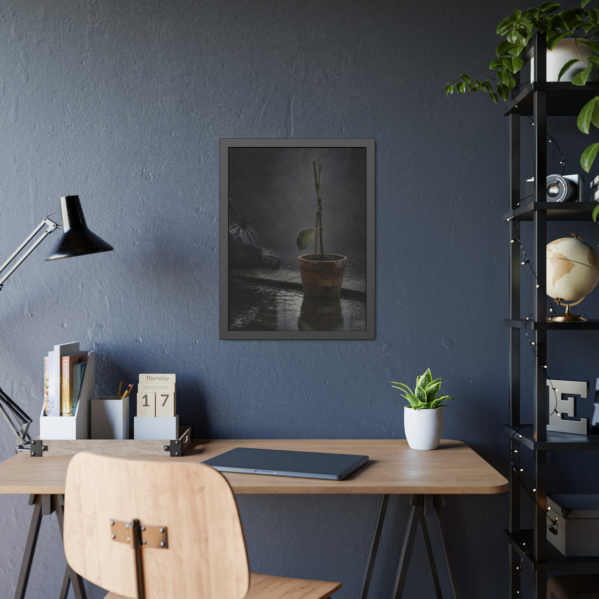 Bare tied stems in a clay pot on flooded pavement, one leaf remaining. The Grey Between by Garabaggio, framed fine art print hanging in a room.