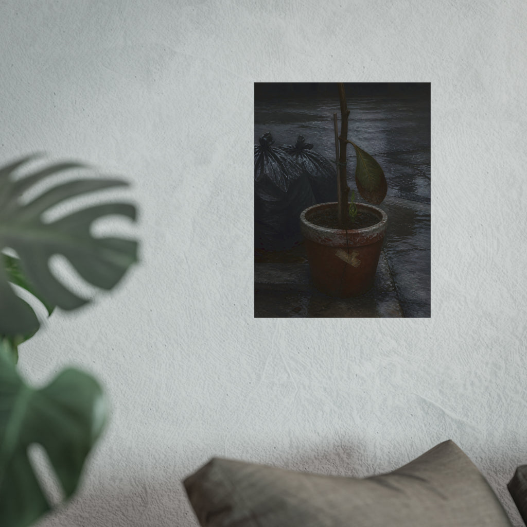 A taped clay pot with one leaf and a green shoot on wet pavement. The Green at the Base by Garabaggio, fine art print hanging in a room.