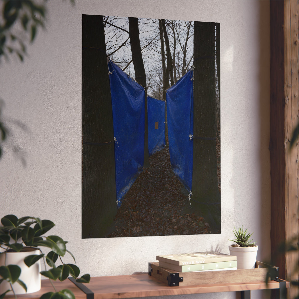 Blue tarps tied between bare trees forming a corridor over dead leaves. Passage Between Trees by Garabaggio, fine art print hanging in a room.