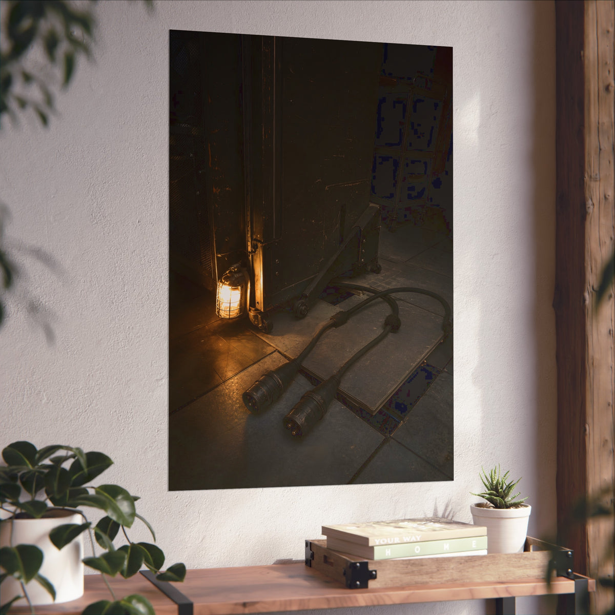 Two thick power cables unplugged on the floor beside a caged work lamp. The Redundant Power by Garabaggio, fine art print hanging in a room.