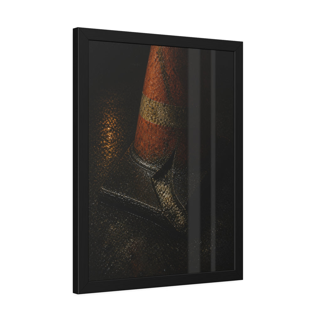 An orange traffic cone with a split base on wet asphalt at night. The Splitting of the Base by Garabaggio, framed fine art print hanging in a room.