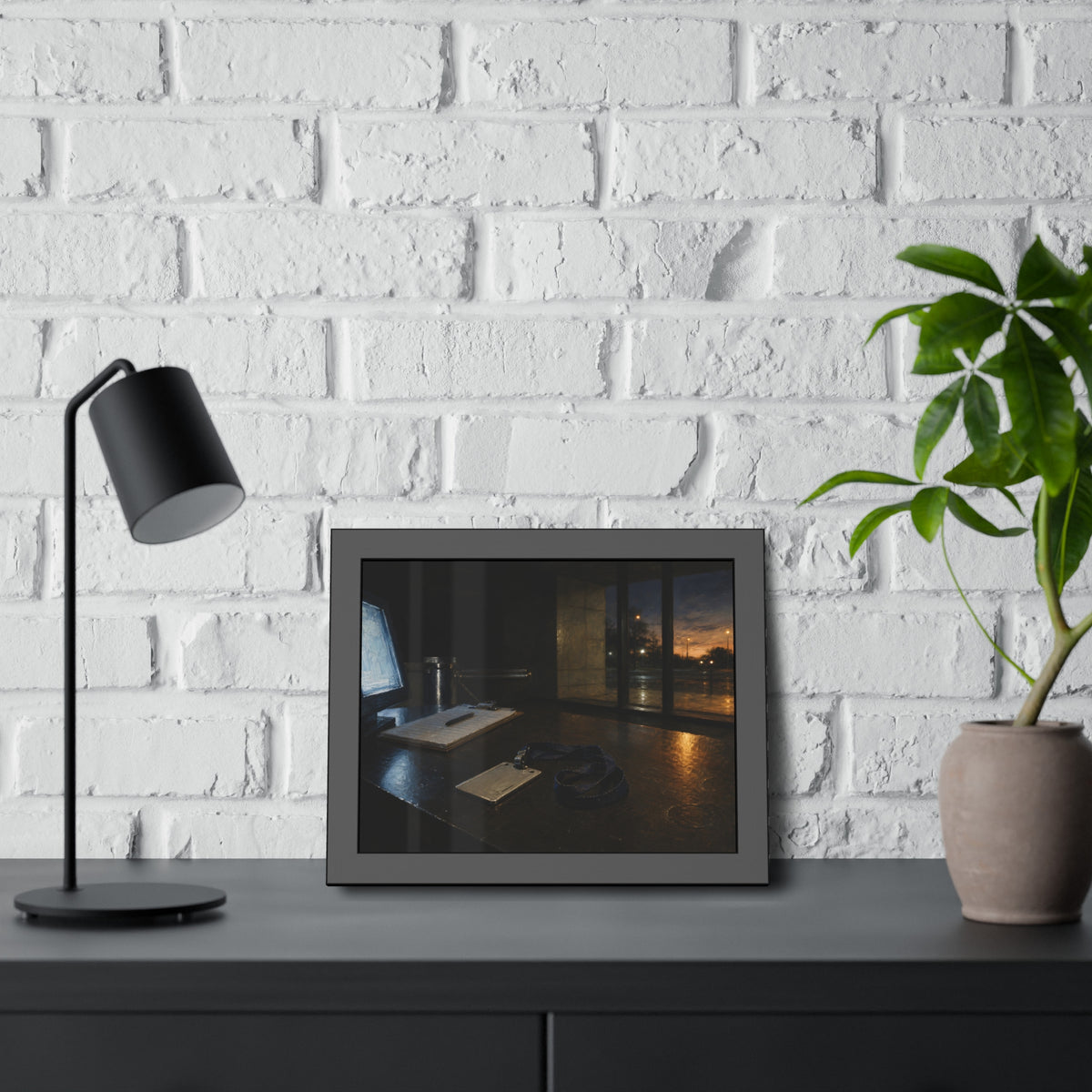 An ID badge and lanyard left on a security desk beside a lit monitor. The Badge on the Security Desk by Garabaggio, framed fine art print hanging in a room.