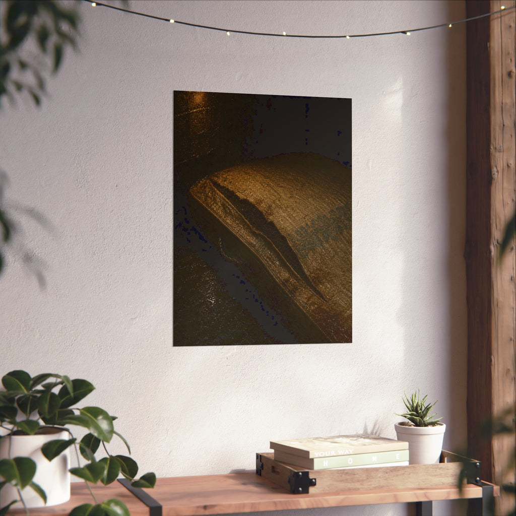 A mattress with its seam split open, lit warm against a dark wall. The Opening of the Ticking by Garabaggio, fine art print hanging in a room.