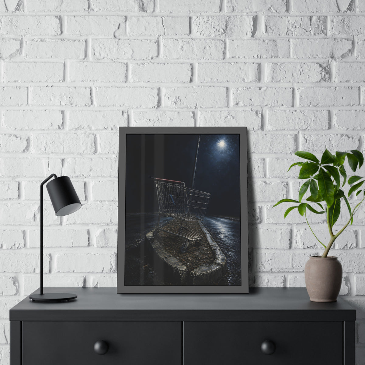 A shopping cart stranded on a stone median under a streetlight. The Crossing of the Median by Garabaggio, framed fine art print hanging in a room.