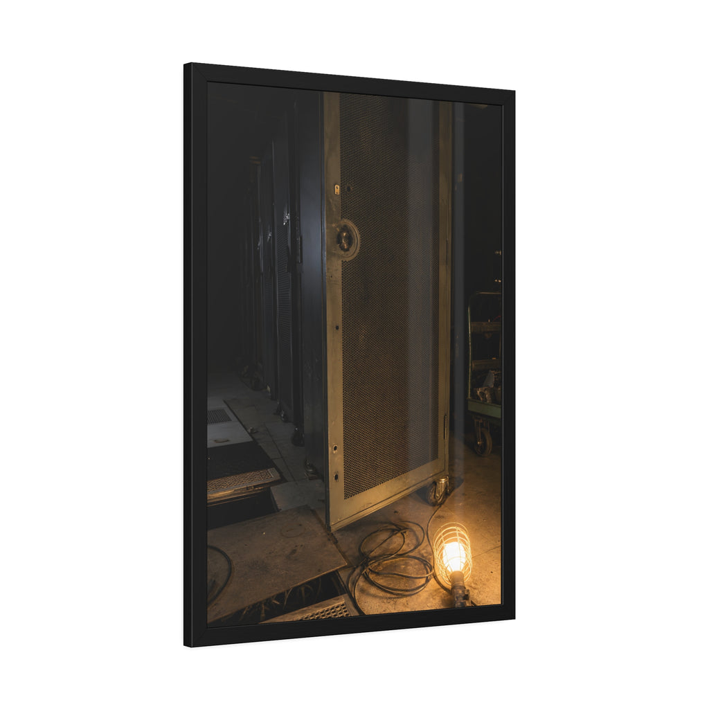 A perforated server rack door in a dark aisle lit by a floor work lamp. The Cold Aisle by Garabaggio, framed fine art print hanging in a room.