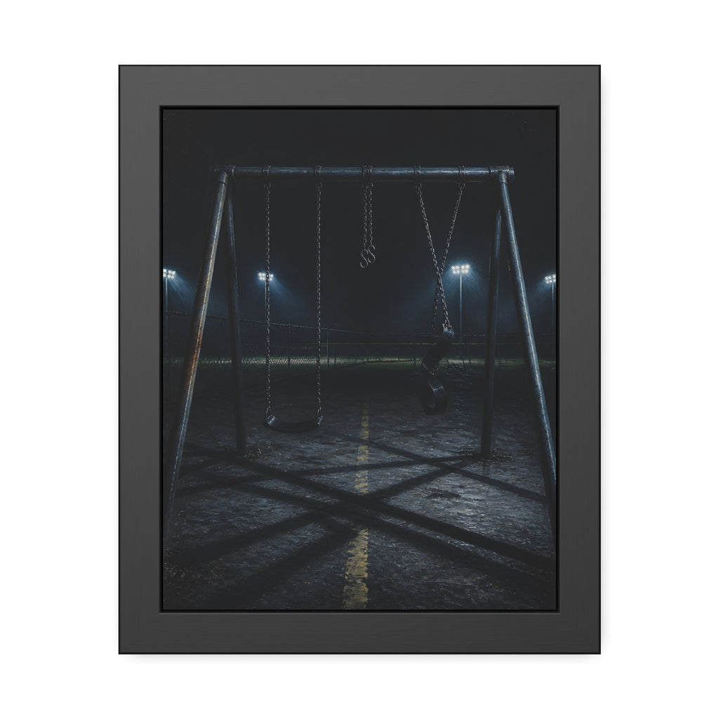 An empty swing set at night with field lights glowing behind it. The Ninth Hour: The Seat Still Moving by Garabaggio, framed fine art print, 11″ x 14″.