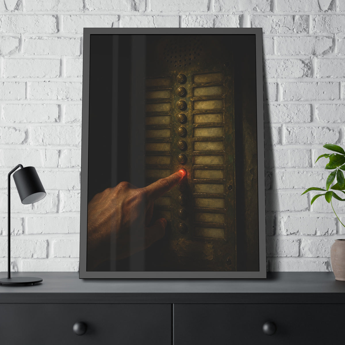 A hand pressing one glowing red button on a worn intercom panel. The Finger at Midnight by Garabaggio, framed fine art print hanging in a room.