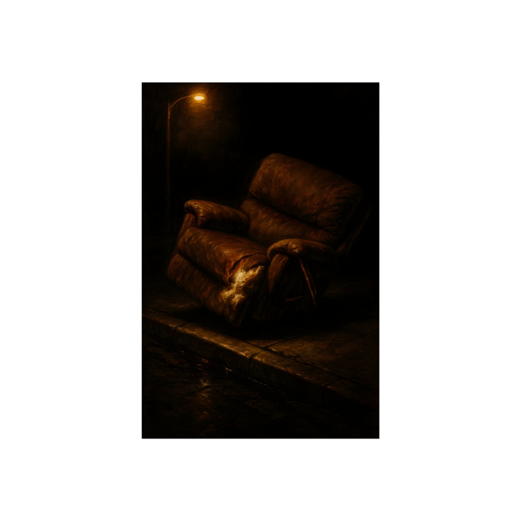 A torn brown recliner tipped on a curb in dim warm light. The Deposition of the Broken Recliner by Garabaggio, fine art print hanging in a room.