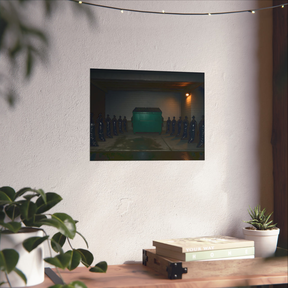 A green dumpster flanked by rows of black garbage bags under a lamp. Night Watch of the Loading Dock by Garabaggio, fine art print hanging in a room.
