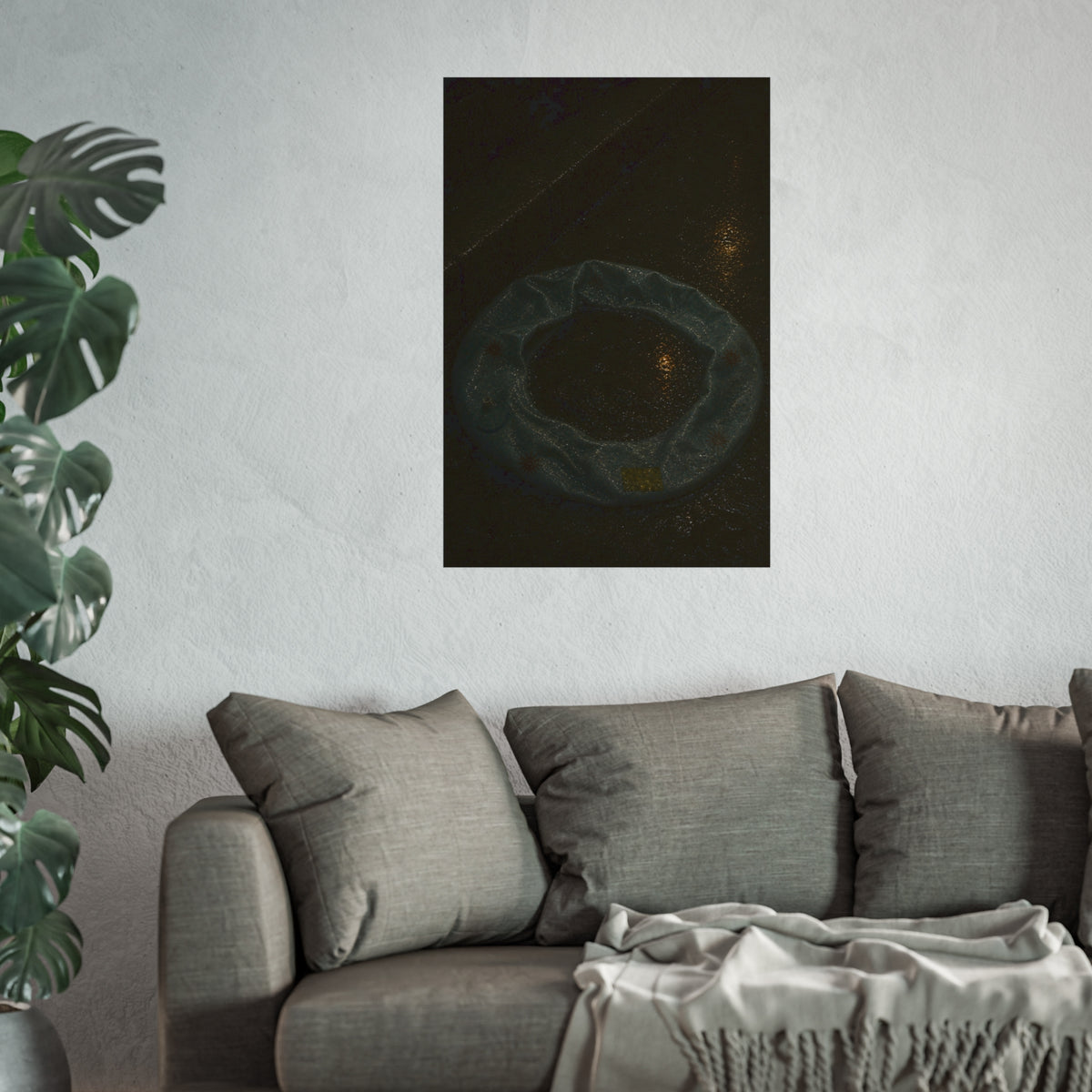 A deflated ring float holding rainwater on wet pavement at night. The Basin of Rain (Pool Float) by Garabaggio, fine art print hanging in a room.