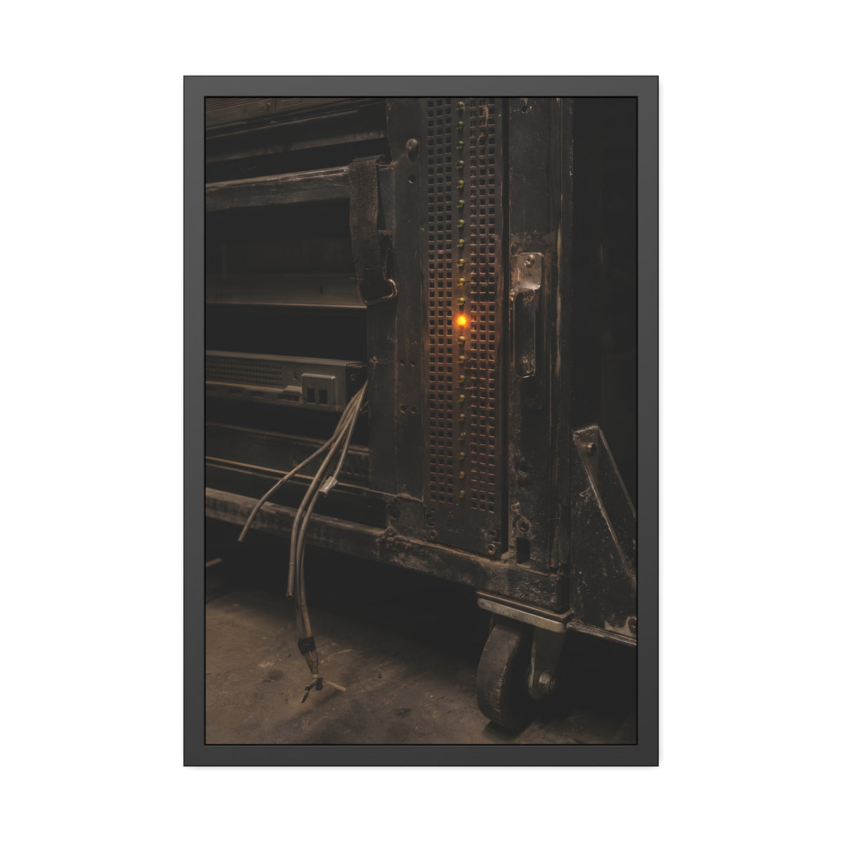 A single amber light among green LEDs on a grimy server rack. The Amber Fault by Garabaggio, framed fine art print, 24″ x 36″.