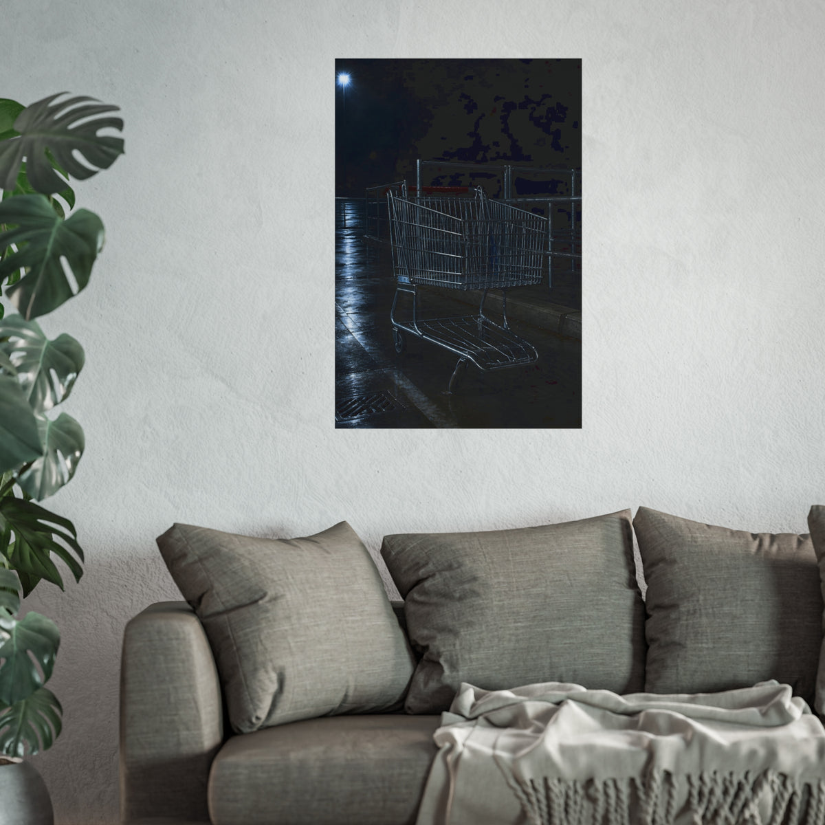 A shopping cart beside its corral on wet asphalt under a lot light. The Cart at the Corral by Garabaggio, fine art print hanging in a room.