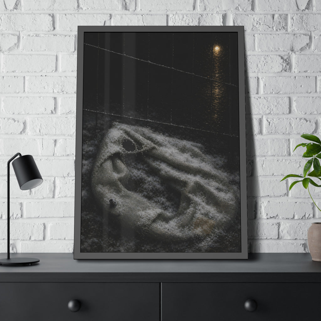 A deflated pool float under snow beside a chain link fence at night. The Bleaching Under Snow by Garabaggio, framed fine art print hanging in a room.