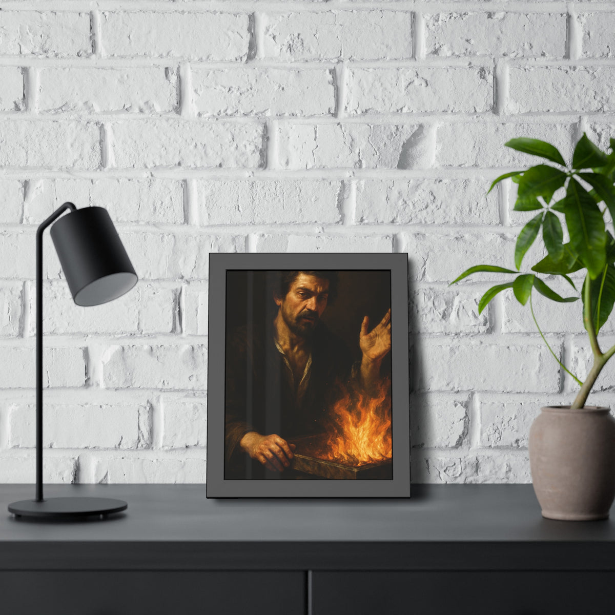 Man holding one hand high over the flames of an open burning bin. Self-Portrait Commanding the Light by Garabaggio, framed fine art print hanging in a room.