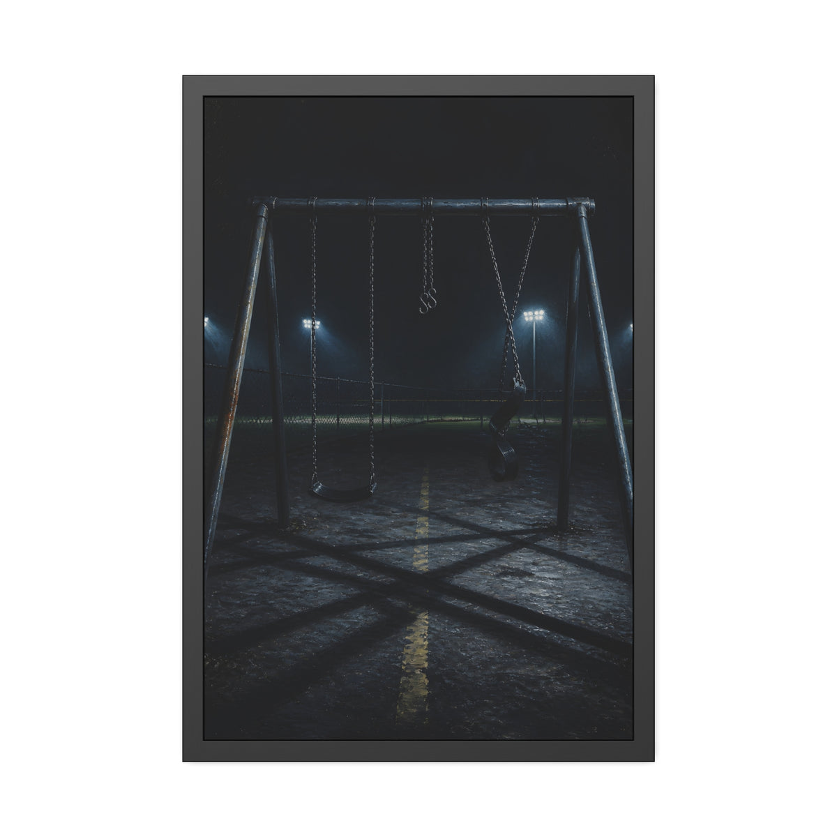 An empty swing set at night with field lights glowing behind it. The Ninth Hour: The Seat Still Moving by Garabaggio, framed fine art print, 24″ x 36″.