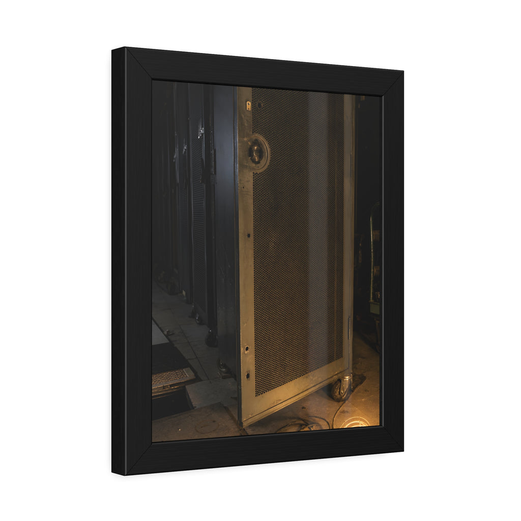 A perforated server rack door in a dark aisle lit by a floor work lamp. The Cold Aisle by Garabaggio, framed fine art print hanging in a room.
