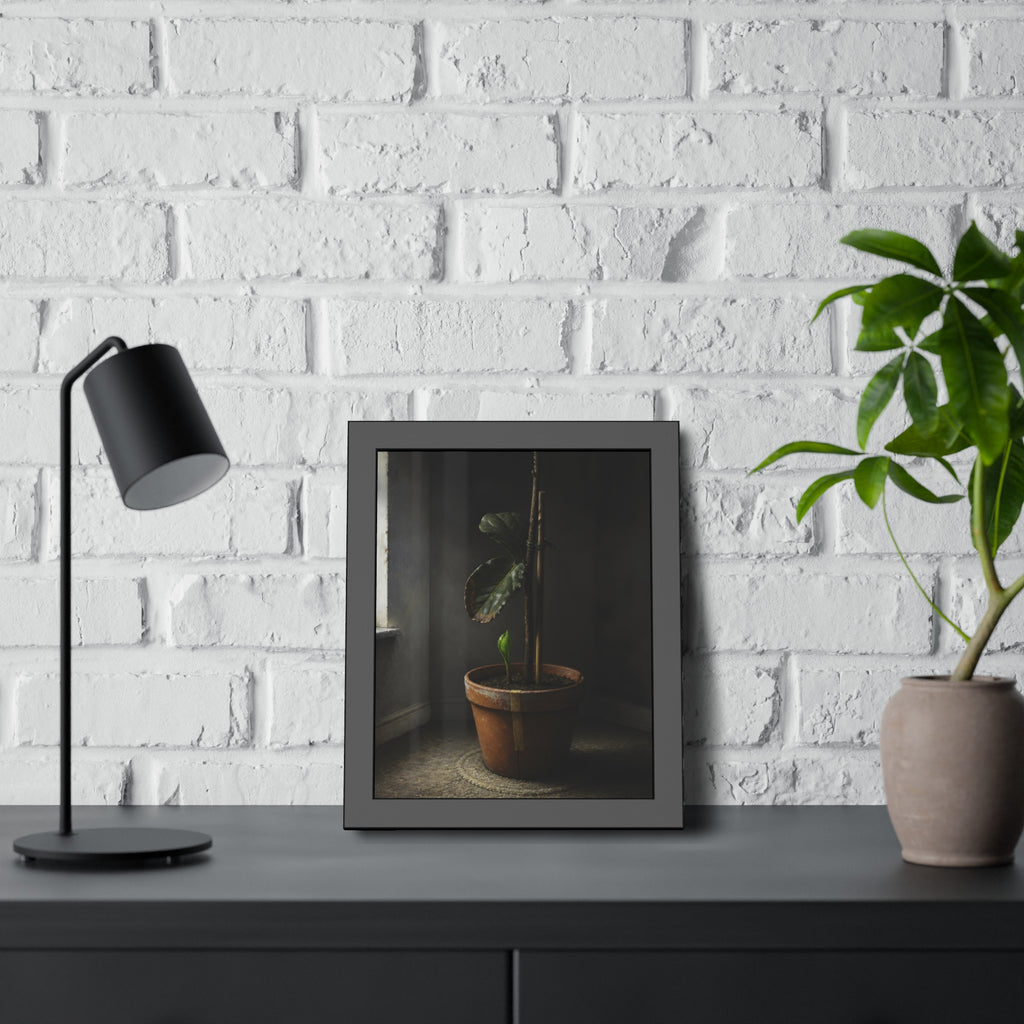 A potted plant down to two curled leaves and one new sprout by a window. The Corner by the Window Again by Garabaggio, framed fine art print hanging in a room.