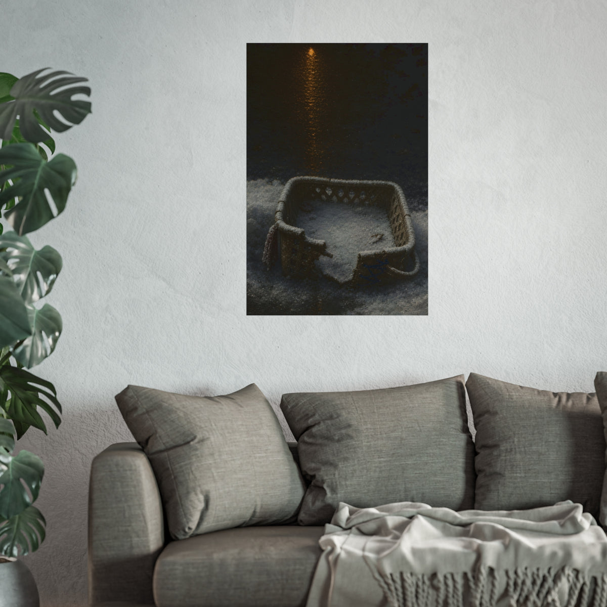 A cracked laundry basket half buried in snow under a distant lamp. The First Snow by Garabaggio, fine art print hanging in a room.