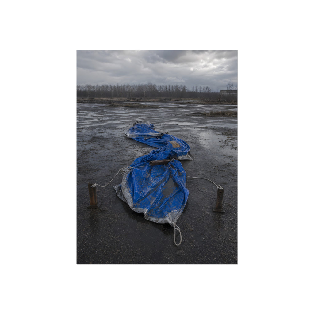 Collapsed blue tarp roped between two posts on wet cracked ground. Collapse Under Wind by Garabaggio, fine art print, 12″ x 16″.