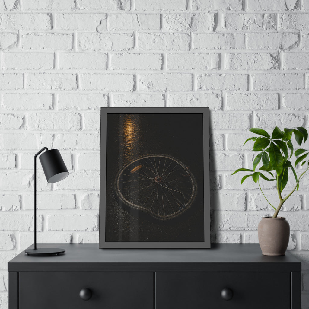 A buckled bicycle wheel on wet asphalt beneath a streetlight reflection. The Bend from Impact by Garabaggio, framed fine art print hanging in a room.