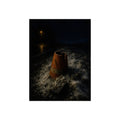 An orange traffic cone half buried in road salt under a distant streetlight. The Burial in Road Salt by Garabaggio, fine art print, 12″ x 16″.