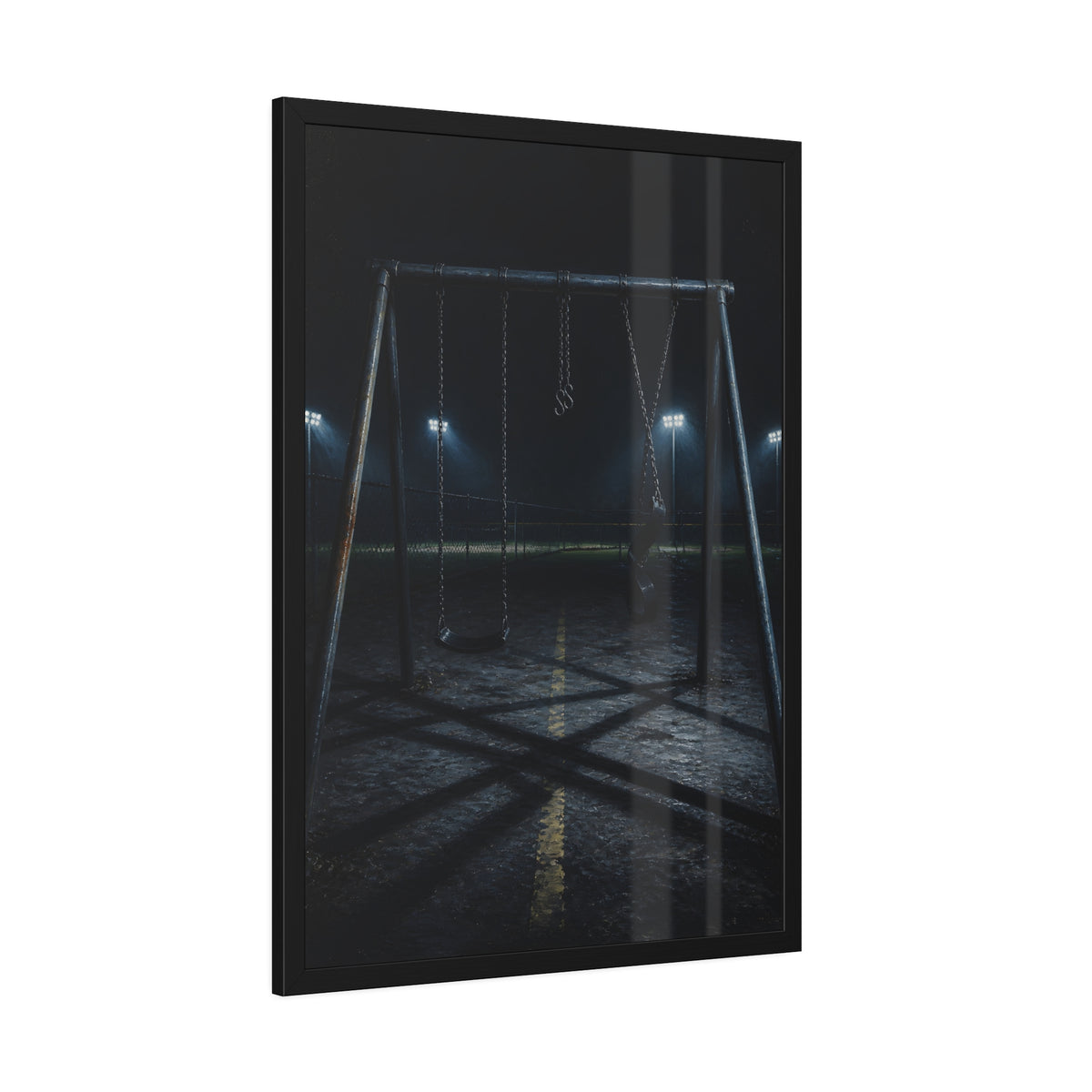 An empty swing set at night with field lights glowing behind it. The Ninth Hour: The Seat Still Moving by Garabaggio, framed fine art print hanging in a room.