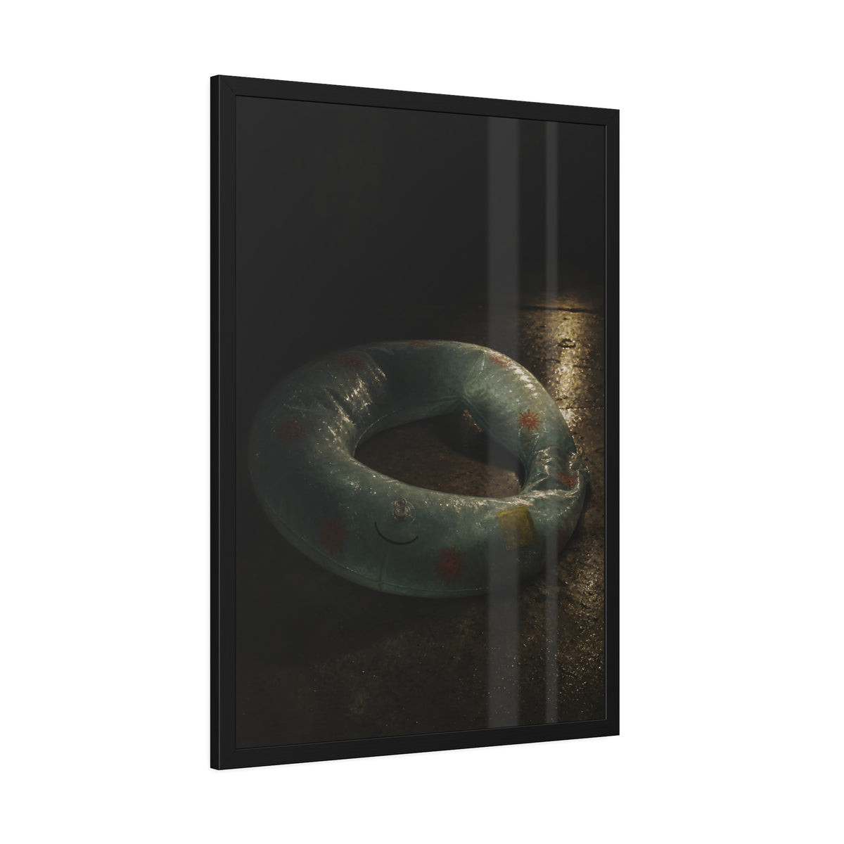 Deflated pool float ring on wet ground, lit from one side in the dark. After the Last Swim by Garabaggio, framed fine art print hanging in a room.
