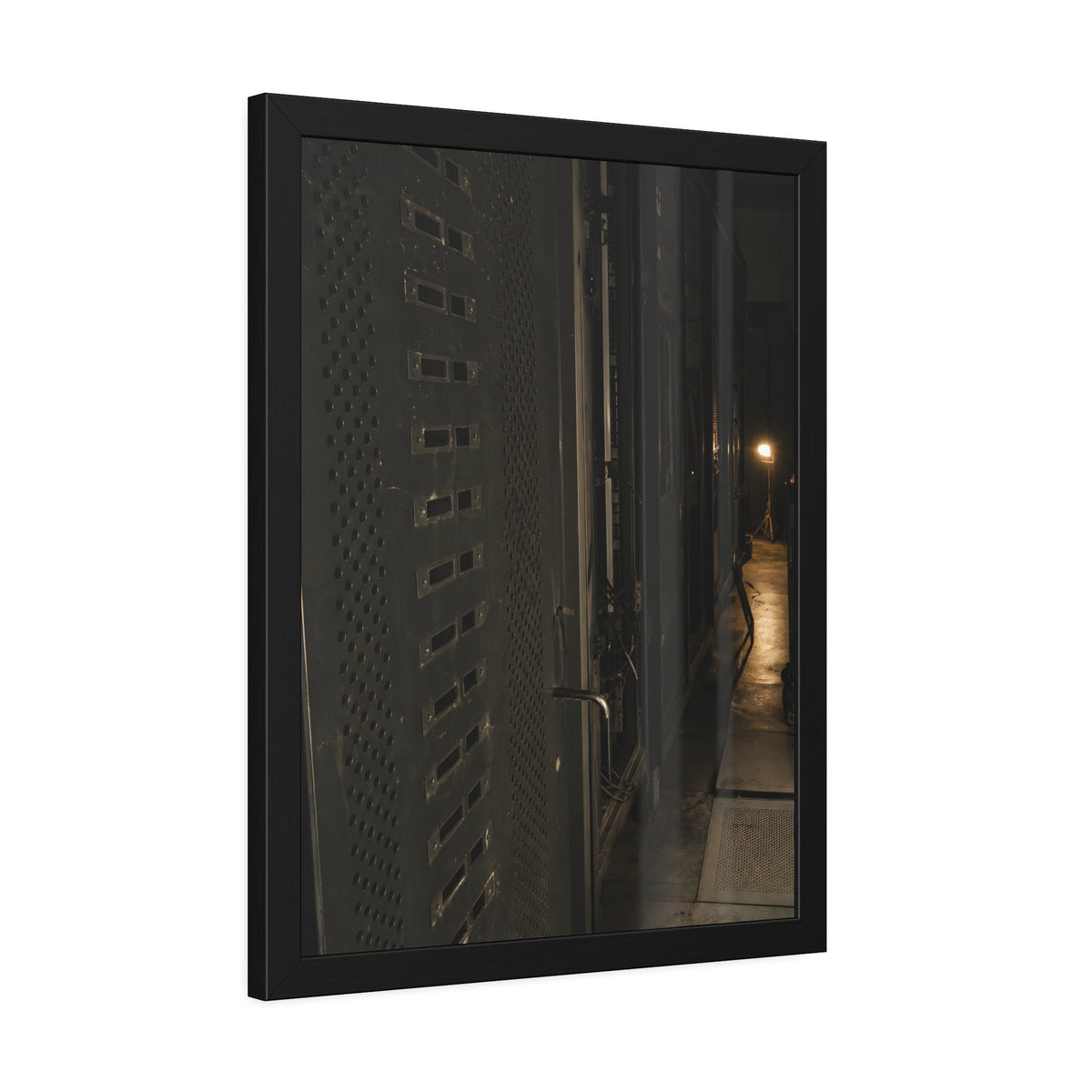 Rows of dark server cabinets with one work lamp glowing far down the aisle. Racks Without Light by Garabaggio, framed fine art print hanging in a room.