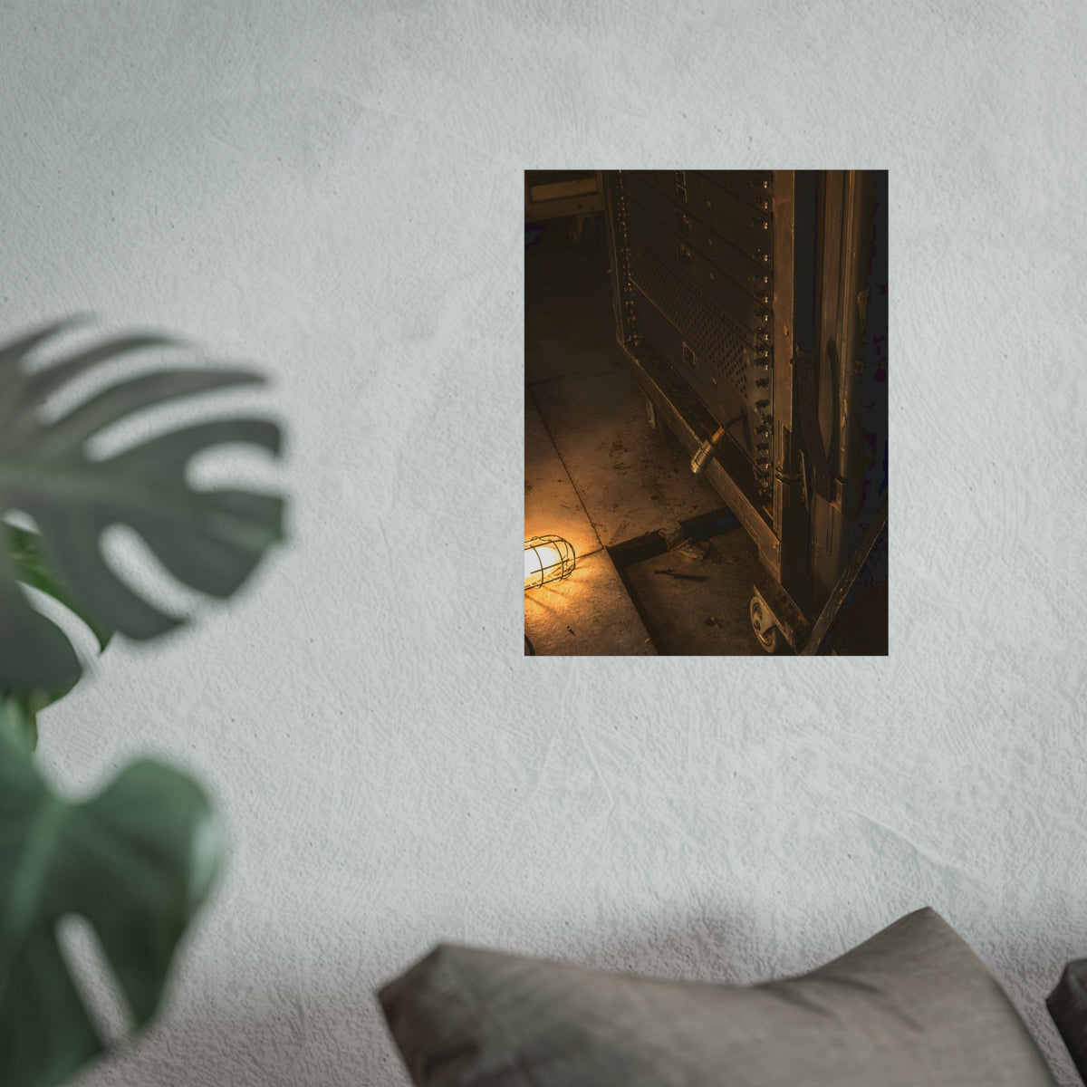 A server rack on a concrete floor beside a caged work light. The Silence at Cutover by Garabaggio, fine art print hanging in a room.