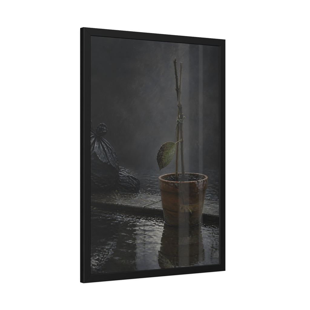 Bare tied stems in a clay pot on flooded pavement, one leaf remaining. The Grey Between by Garabaggio, framed fine art print hanging in a room.