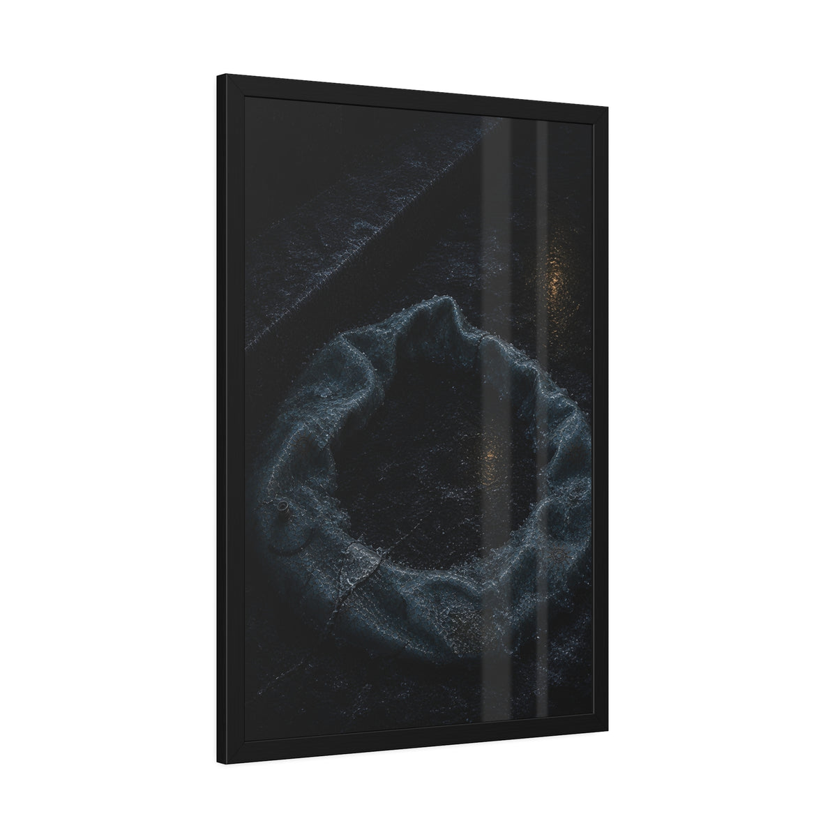 A deflated ring float collapsed on wet pavement under distant amber light. The Freezing of the Smile by Garabaggio, framed fine art print hanging in a room.