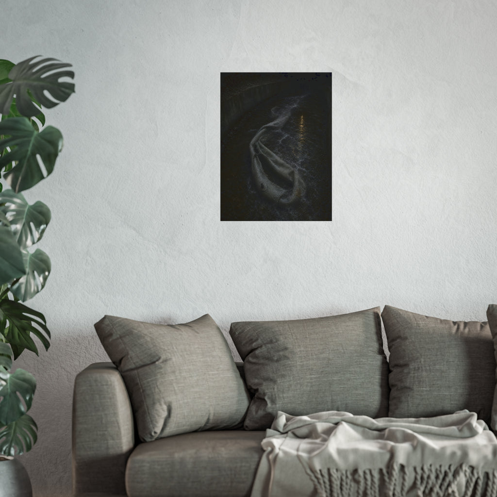 A deflated pool float caught in a concrete drainage channel of running water. The Release into Runoff by Garabaggio, fine art print hanging in a room.