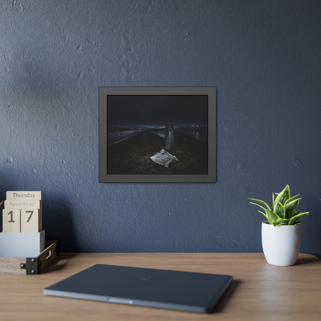 A sheet of paper on a grassy highway median beside a concrete post at night. The Resume on the Median by Garabaggio, framed fine art print hanging in a room.