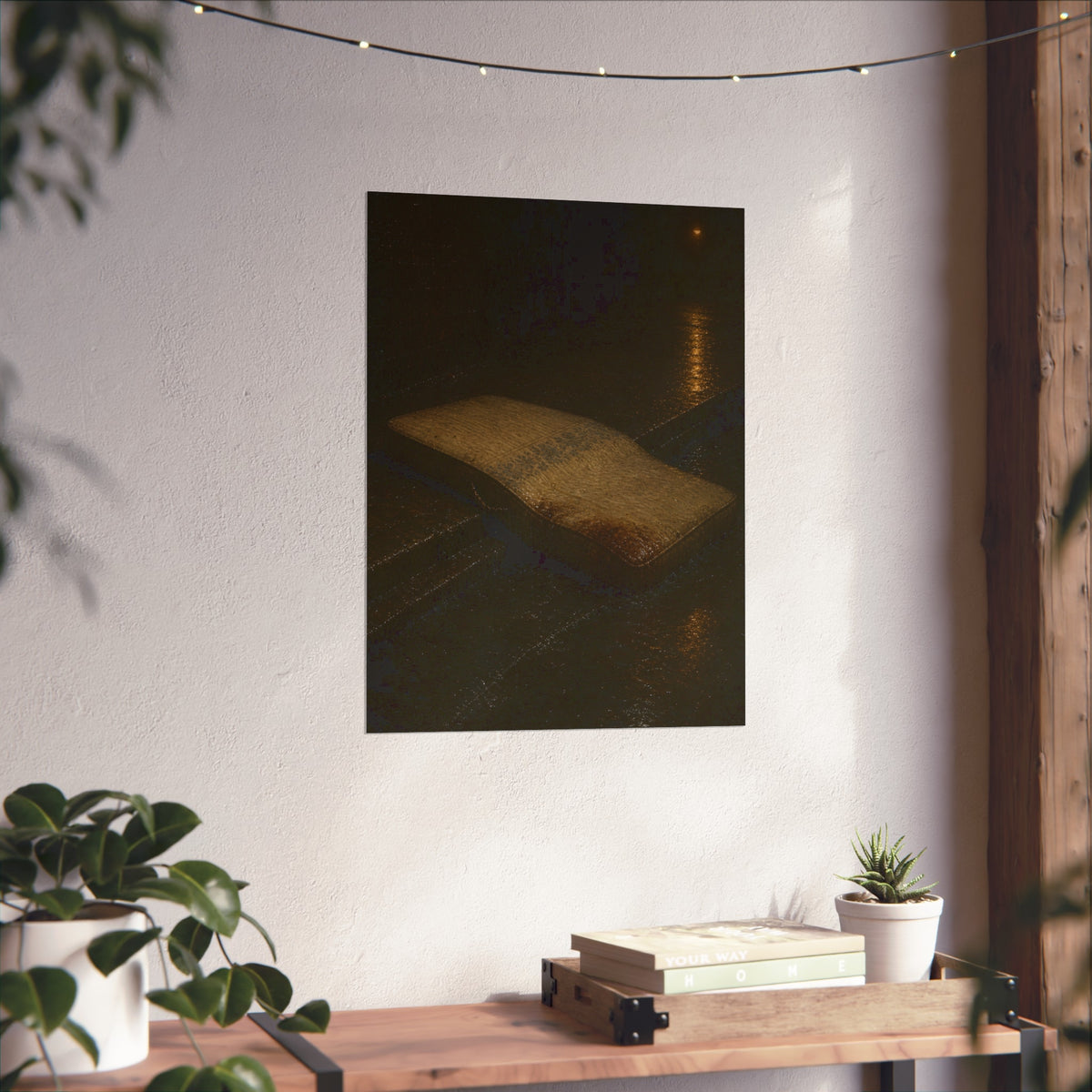 A sodden mattress slumped off a curb on wet pavement under a street lamp. The Collapse into the Gutter by Garabaggio, fine art print hanging in a room.