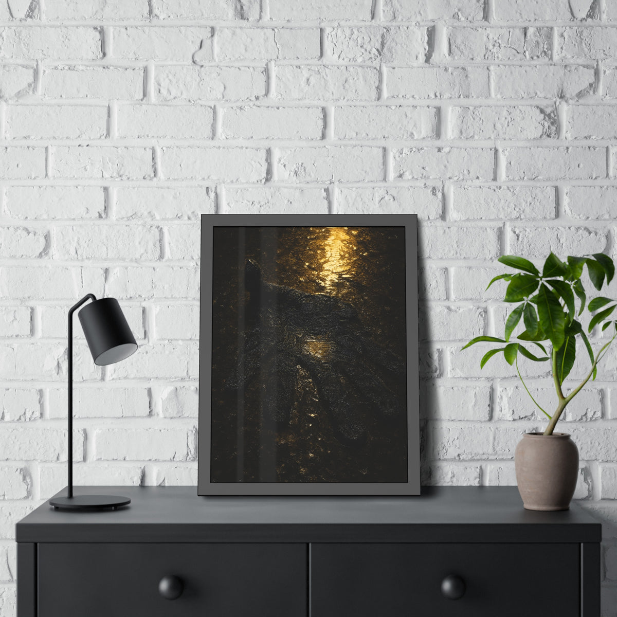 A flattened black glove pressed into wet asphalt beside a light streak. The Flattening, Study No. 1 by Garabaggio, framed fine art print hanging in a room.