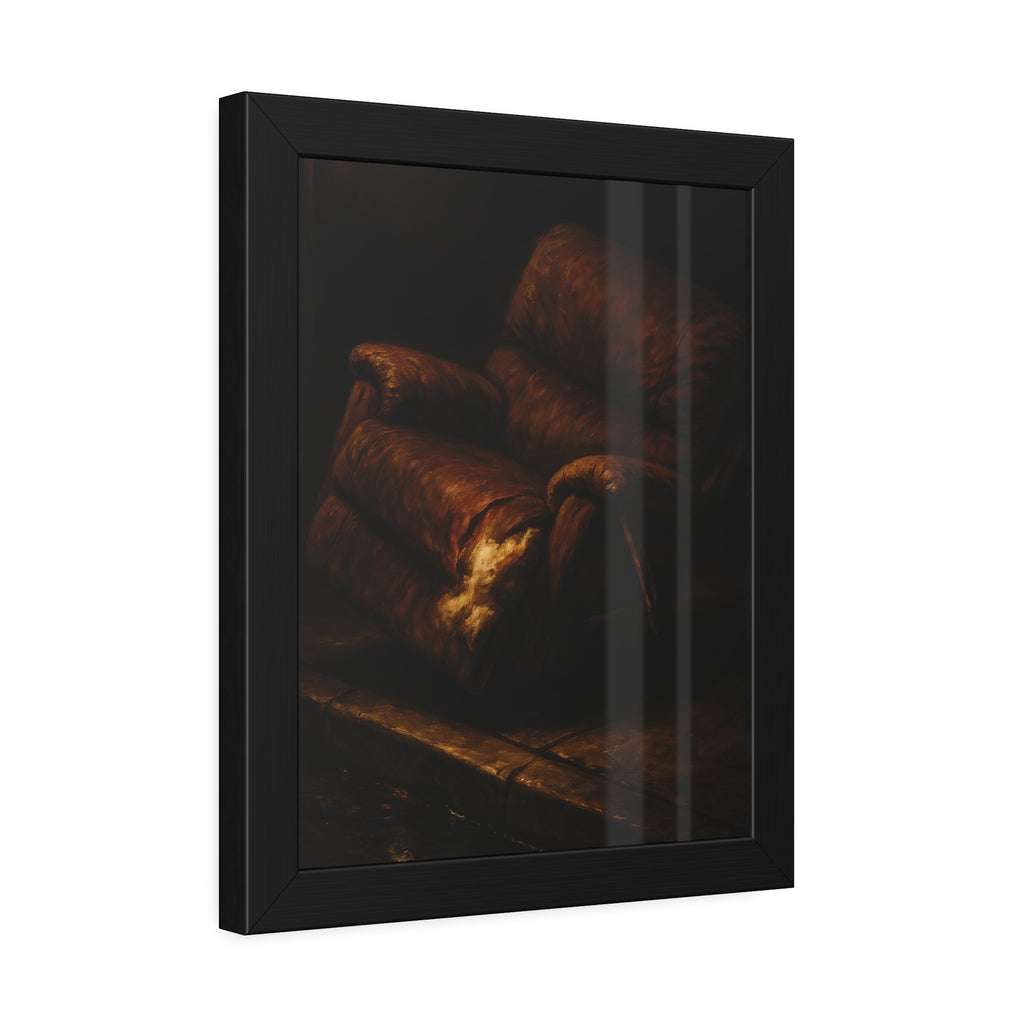 A torn brown recliner tipped on a curb in dim warm light. The Deposition of the Broken Recliner by Garabaggio, framed fine art print hanging in a room.